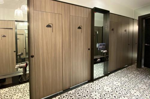 a row of wooden lockers in a bathroom at ST Signature Jalan Besar in Singapore