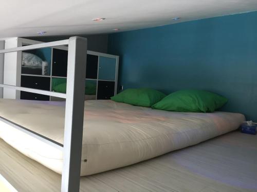 - une chambre avec des lits superposés et des oreillers verts dans l'établissement Appartement front Marina, au Cap d'Agde