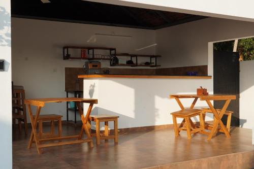 a group of tables and chairs in a room at Kaayal Villa Lakefront Retreat in Varkala in Varkala