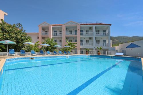 a large swimming pool in front of a hotel at Dolphin Hotel in Skopelos Town