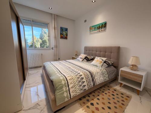 a bedroom with a bed and a window at most charming 2 bedrooms in la Marsa in La Marsa