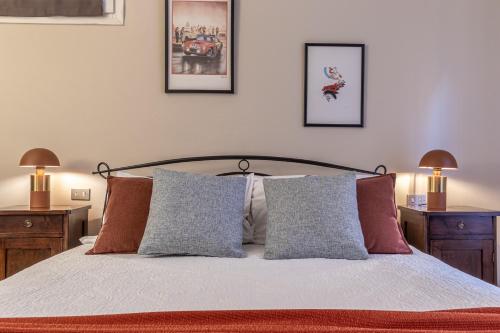 a bedroom with a bed with three pictures on the wall at Room & Breakfast Canalino 21 in Modena
