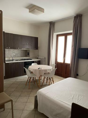 a room with a bed and a table and a kitchen at BBuSS Country Club in Catanzaro