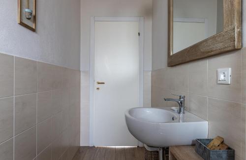 a bathroom with a sink and a mirror at Room & Breakfast Canalino 21 in Modena