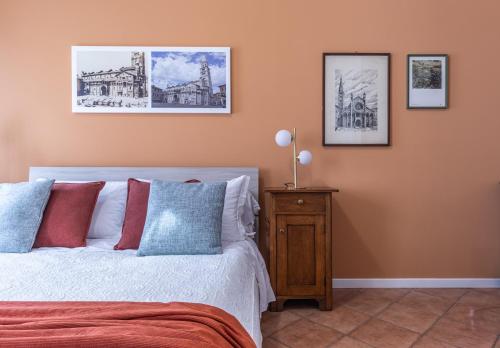a bedroom with a bed and pictures on the wall at Room & Breakfast Canalino 21 in Modena