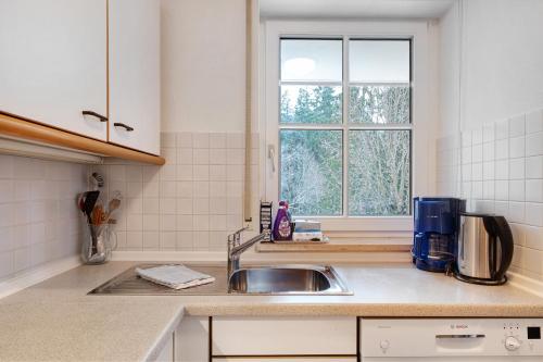 a kitchen with a sink and a window at Haus an der Gutach in Titisee-Neustadt