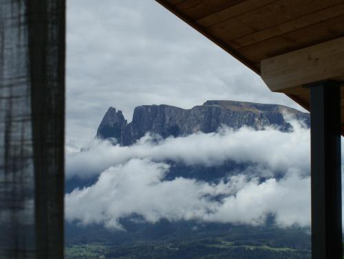 a view of the table mountain from a window at Alpenglow Apartments in Collalbo