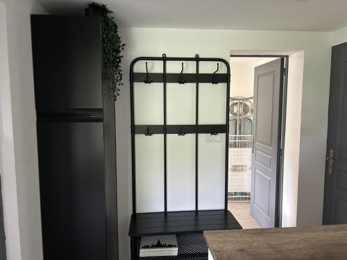 a kitchen with a black and white door and a table at T2 Mouguerre aux portes de Bayonne et Biarritz in Mouguerre