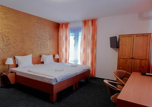 a hotel room with a bed and a window at Hotel Esprit in Špindlerův Mlýn