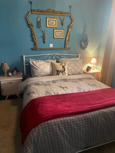 a bedroom with a large bed with a red blanket at D&S home oinofita in Oinófita