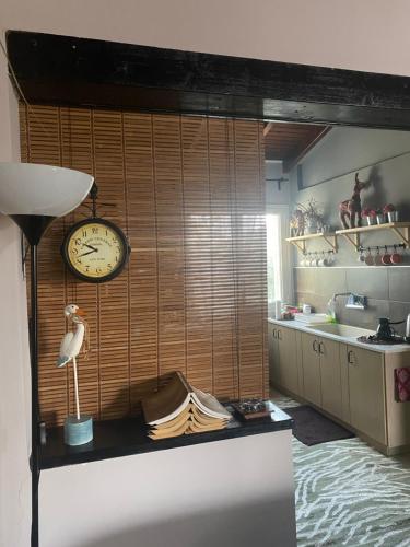 a kitchen with a clock on the wall and a counter at D&S home oinofita in Oinófita