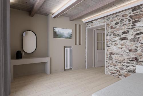 a room with a stone wall and a mirror at Ktima Faki, Olympus Mountain Accommodation & Retreat in Litochoro