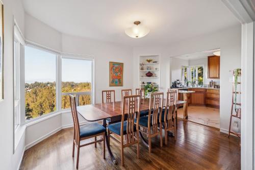 a kitchen and dining room with a table and chairs at Charming 1933 Ridge-Top Home with Stunning Views home in Oakland