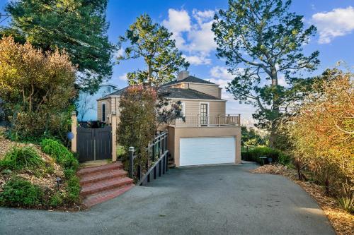 a house with a gate and a garage at Charming 1933 Ridge-Top Home with Stunning Views home in Oakland