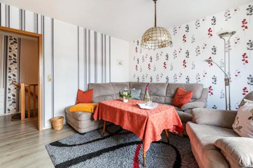 a living room with a couch and a table at Haus Dreeßen in Buchholz