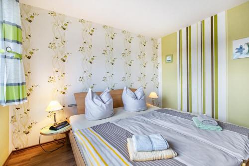 a bedroom with a bed with two pillows on it at Haus Dreeßen in Buchholz
