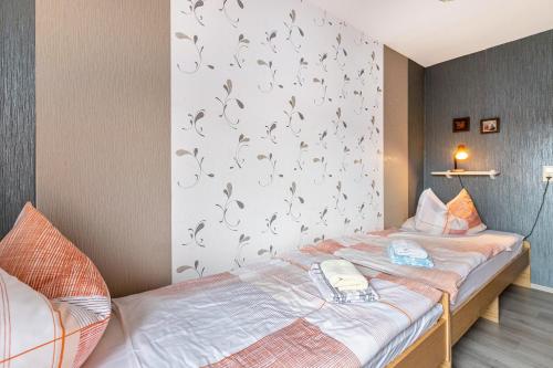 a bedroom with a bed with butterflies on the wall at Haus Dreeßen in Buchholz