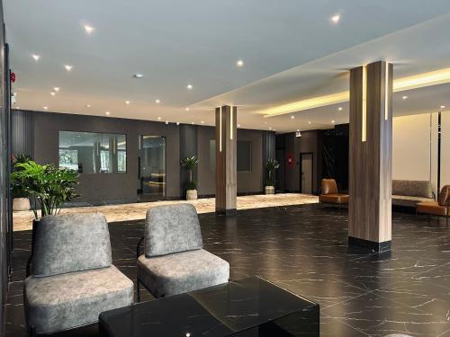 a lobby with two chairs and a table at LION 15 Hotel in Can Tho