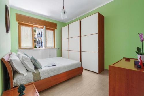 a bedroom with a bed and a window at Rose Sorrento House in Sorrento