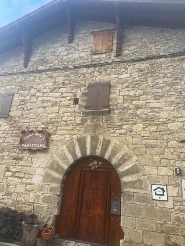 a stone building with a wooden door in front of it at Casa Rural Ardantzena in Ardaiz