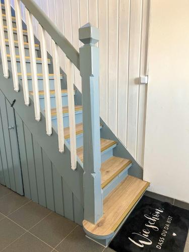 a set of stairs with a wooden stair case at FeWo Ostseeglück in Biendorf