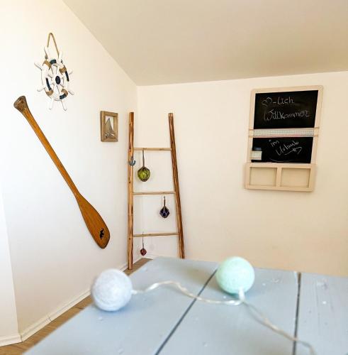 a room with a table and a chalkboard on the wall at FeWo Ostseeglück in Biendorf