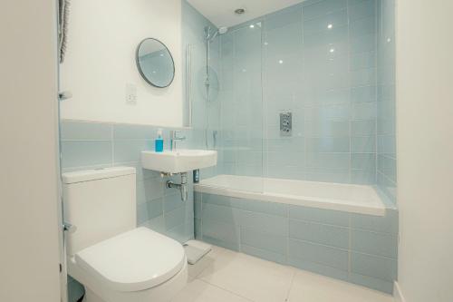 a bathroom with a toilet and a sink and a tub at Executive Coach House on the Hoe 2 free parking spaces in Plymouth