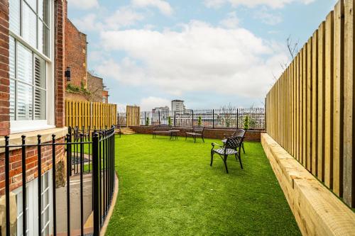 a balcony with a green yard with benches on it at St Marys Quarters in Nottingham