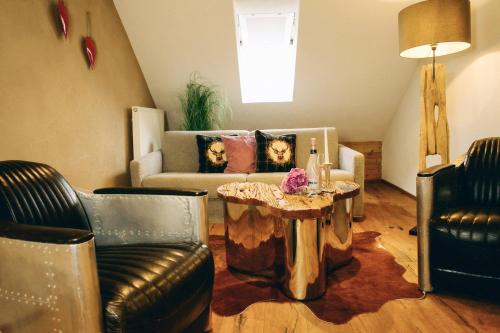 a living room with a couch and a coffee table at Mäsers Allgäuherz in Wiggensbach