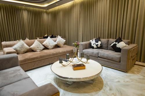 a living room with two couches and a coffee table at Royal Cabana Lonavla - 6BHK Luxury Villa with Heated pool and Turf in Lonavala