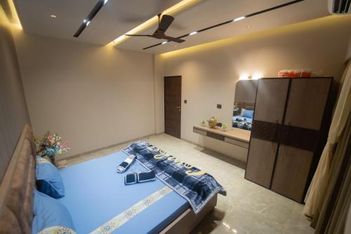 a bedroom with a bed and a ceiling fan at Royal Cabana Lonavla - 6BHK Luxury Villa with Heated pool and Turf in Lonavala