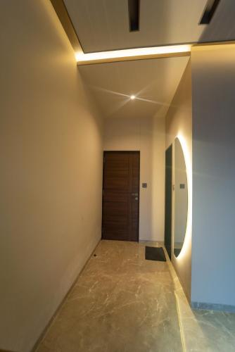 a room with a hallway with a door at Royal Cabana Lonavla - 6BHK Luxury Villa with Heated pool and Turf in Lonavala