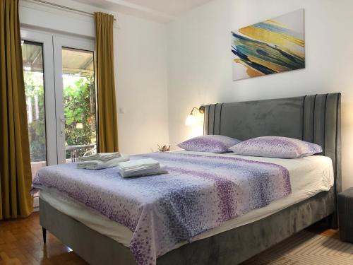 a bedroom with a bed with purple sheets and pillows at Double room with bathroom, beach close, kitchen use in Medulin