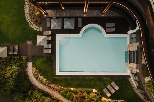 an overhead view of a building with a swimming pool at Granbaita Dolomites in Selva di Val Gardena
