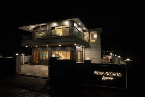 a large house at night with lights on it at Royal Cabana Lonavla - 6BHK Luxury Villa with Heated pool and Turf in Lonavala