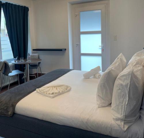 a large white bed with a tray on top of it at Veyrier Salève-Genève Pas-de-L'Echelle in Veyrier