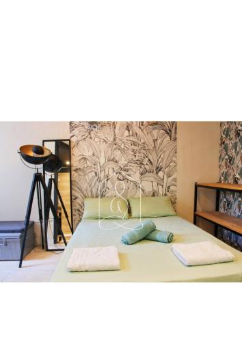 a bedroom with a bed with two towels on it at La Vague, au coeur du village de Montauroux in Montauroux
