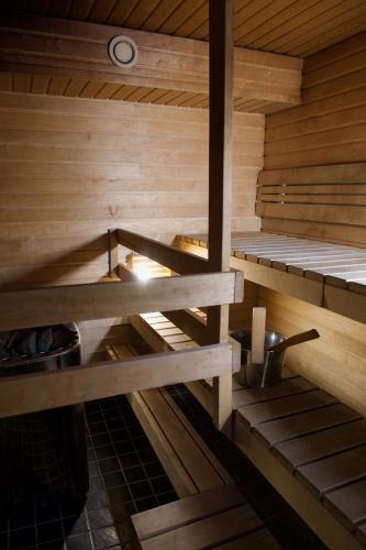 an inside of a sauna with two bunk beds at Taigaschool Eco Hotel in Virrankylä