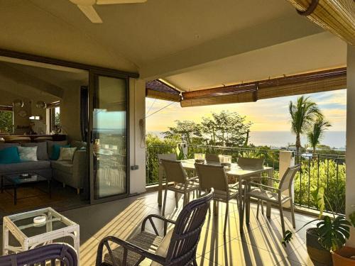 a patio with a table and chairs on a balcony at Seaview Sunset Apartment 2 in Rivière Noire