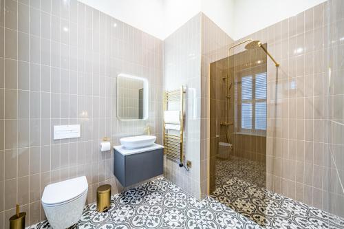 a bathroom with a toilet and a sink and a shower at St Marys Quarters in Nottingham