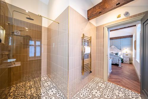 a bathroom with a walk in shower and a glass door at St Marys Quarters in Nottingham