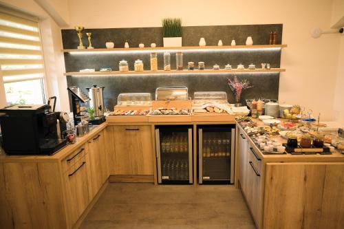 a kitchen with wooden cabinets and a counter top at Penzion U Nováků in Kožlí u Orlíka