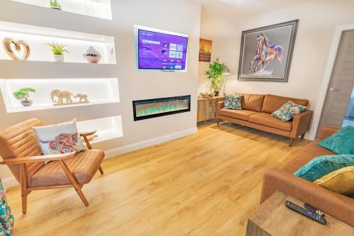 a living room with a couch and a tv at The Townhouse Ballycastle in Ballycastle