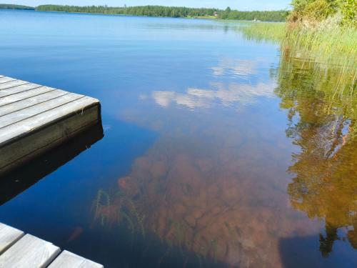 a view of a lake with a dock at Taigaschool Eco Hotel in Virrankylä