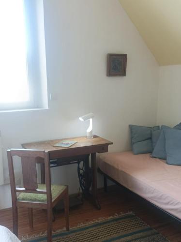 Cette chambre comprend un bureau et un lit. dans l'établissement Maison TOTORO, à Heugueville-sur-Sienne