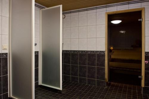 an open door in a bathroom with a hallway at Taigaschool Eco Hotel in Virrankylä