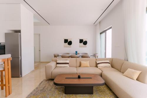 a living room with a couch and a table at Akamas Luxury Villas in Paphos