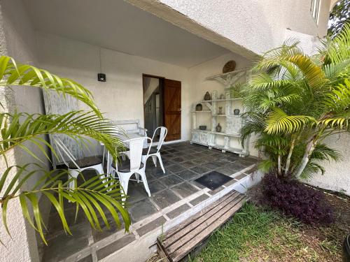 a porch of a house with a table and chairs at Marine House Pointe d'Esny in Blue Bay