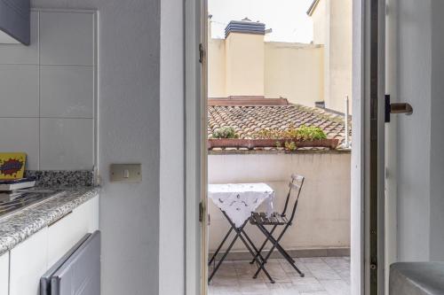 a view of a kitchen with a table and a chair at Room & Breakfast Canalino 21 in Modena