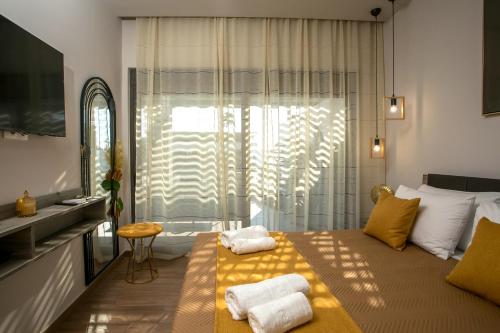 a bedroom with a bed with towels on it at Kiki Luxury Villa in Afantou